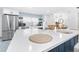 Open concept kitchen featuring a large island with white countertops and modern appliances at 2244 Glenmoor N Rd, Clearwater, FL 33764