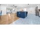 Bright, open kitchen with a blue island, stainless steel appliances, and hardwood flooring at 2244 Glenmoor N Rd, Clearwater, FL 33764
