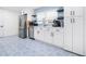 Bright kitchen featuring stainless steel appliances and beautiful blue patterned tile floors at 2244 Glenmoor N Rd, Clearwater, FL 33764