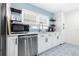 Clean kitchen design with white cabinetry, stainless steel appliances, and bright natural light at 2244 Glenmoor N Rd, Clearwater, FL 33764