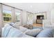 Bright living room with large windows, plush sofa, and matching striped chairs at 2244 Glenmoor N Rd, Clearwater, FL 33764