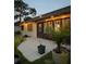 Backyard patio with string lights and lush tropical plants, perfect for outdoor entertaining at 2250 Sequoia Dr, Clearwater, FL 33763