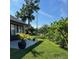 Lush backyard featuring green lawn, patio, and mature landscaping at 2250 Sequoia Dr, Clearwater, FL 33763
