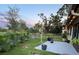 Sprawling backyard with a patio, lush greenery, and mature trees, perfect for outdoor activities at 2250 Sequoia Dr, Clearwater, FL 33763