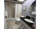 Bathroom featuring vanity with dark granite countertop and tub with shower at 2250 Sequoia Dr, Clearwater, FL 33763