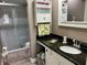Bathroom featuring vanity with granite countertop and a glass-enclosed shower at 2250 Sequoia Dr, Clearwater, FL 33763