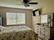 Relaxing bedroom featuring a queen-size bed, ceiling fan, TV, and dresser at 2250 Sequoia Dr, Clearwater, FL 33763