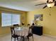 Inviting dining room featuring a glass table, artwork, and a ceiling fan at 2250 Sequoia Dr, Clearwater, FL 33763