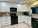 Bright kitchen featuring granite counters, tile backsplash, and modern appliances at 2250 Sequoia Dr, Clearwater, FL 33763