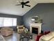 Cozy living room boasts a fireplace, ceiling fan, and comfortable seating under natural light at 2250 Sequoia Dr, Clearwater, FL 33763