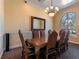 Traditional dining room featuring a large wooden table and ornate chandelier at 2709 Via Cipriani # 522B, Clearwater, FL 33764