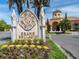 Grand Bellagio entrance with stone monument, beautiful landscaping, and elegant building architecture at 2709 Via Cipriani # 522B, Clearwater, FL 33764