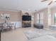 Cozy living room featuring fireplace, large windows, neutral paint, and dining area at 2709 Via Cipriani # 522B, Clearwater, FL 33764