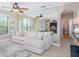 Bright living room with large couch, mirrored wall, and stylish decor at 2709 Via Cipriani # 522B, Clearwater, FL 33764