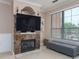 Cozy living room featuring a fireplace, large screen television, and window seating at 2709 Via Cipriani # 522B, Clearwater, FL 33764