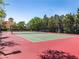 Well-maintained community tennis court surrounded by lush greenery at 2709 Via Cipriani # 522B, Clearwater, FL 33764
