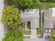 Aerial view of the home showcases the roof, driveway, and lush landscaping at 2859 Thistle N Ct, Palm Harbor, FL 34684