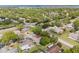Aerial view of a quiet neighborhood shows lush landscaping and proximity to town at 2859 Thistle N Ct, Palm Harbor, FL 34684