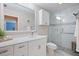 Modern bathroom featuring a walk-in shower with decorative tile, a sleek vanity, and bright, neutral colors at 2859 Thistle N Ct, Palm Harbor, FL 34684