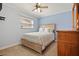 Serene bedroom with a soft blue color scheme, a plush bed, and a window with natural light at 2859 Thistle N Ct, Palm Harbor, FL 34684