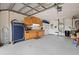 Spacious garage with storage cabinets, pegboard, and a utility sink perfect for projects and organization at 2859 Thistle N Ct, Palm Harbor, FL 34684