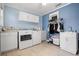 Bright laundry room with a washer, dryer, cabinets, and a sink in a well lit area at 2859 Thistle N Ct, Palm Harbor, FL 34684