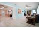 Spacious living room with wood-look tile, stylish furniture, and bright, cheerful wall colors at 2859 Thistle N Ct, Palm Harbor, FL 34684