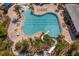 Overhead view of an inviting pool with a waterslide, palm trees, and lounge chairs for relaxation at 2935 Winglewood Cir, Lutz, FL 33558