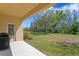 Spacious backyard featuring a lush lawn and mature trees, creating a serene outdoor space at 2935 Winglewood Cir, Lutz, FL 33558