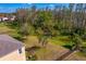 Expansive backyard with mature trees and partial fence, ideal for outdoor activities and enjoying nature at 2935 Winglewood Cir, Lutz, FL 33558