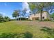 Spacious backyard with lush green grass and mature trees, ideal for outdoor activities at 2935 Winglewood Cir, Lutz, FL 33558