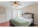 Comfortable bedroom featuring wood floors, a ceiling fan, and ample natural light at 2935 Winglewood Cir, Lutz, FL 33558