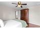 Comfortable bedroom featuring wood floors and a large wooden armoire at 2935 Winglewood Cir, Lutz, FL 33558