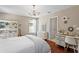 Bright bedroom featuring a decorative chandelier, hardwood floors, and stylish furnishings at 2935 Winglewood Cir, Lutz, FL 33558