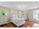 Bedroom featuring decorative headboard and bright windows at 2935 Winglewood Cir, Lutz, FL 33558