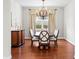 Formal dining room featuring hardwood floors, chandelier lighting, and neutral color walls at 2935 Winglewood Cir, Lutz, FL 33558