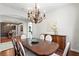 Open formal dining room featuring hardwood floors, chandelier lighting, and neutral color walls at 2935 Winglewood Cir, Lutz, FL 33558