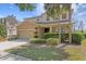 Charming two-story home with well-manicured landscaping and a two-car garage at 2935 Winglewood Cir, Lutz, FL 33558