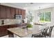 This kitchen features stainless appliances, custom cabinets, granite counters and a central island with barstool seating at 2935 Winglewood Cir, Lutz, FL 33558