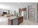 Open kitchen features an island, stainless appliances, granite countertops, and dark wood cabinetry at 2935 Winglewood Cir, Lutz, FL 33558