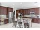 This gourmet kitchen includes stainless appliances, custom cabinets, granite counters and a central island for dining at 2935 Winglewood Cir, Lutz, FL 33558