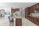 Open kitchen boasts a large island, granite countertops, stainless steel appliances, and ample cabinet space at 2935 Winglewood Cir, Lutz, FL 33558