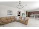 Bright living room overlooks kitchen area and features neutral paint, stylish chandelier for a modern look at 2935 Winglewood Cir, Lutz, FL 33558