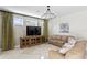 Bright living room features neutral paint, stylish chandelier and large media center for a modern look at 2935 Winglewood Cir, Lutz, FL 33558