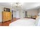 Bright main bedroom featuring wood floors, modern chandelier, and a spacious layout at 2935 Winglewood Cir, Lutz, FL 33558