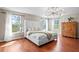 Bright main bedroom with hardwood floors, large windows, and elegant furnishings at 2935 Winglewood Cir, Lutz, FL 33558