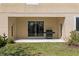 Covered patio with a grill and lush green lawn, perfect for relaxing at 2935 Winglewood Cir, Lutz, FL 33558