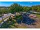Aerial view of community playground surrounded by green space and mature trees, perfect for Gathering outings at 2935 Winglewood Cir, Lutz, FL 33558