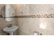 Elegant powder room with pedestal sink, stylish mirror, neutral paint and mosaic tile accent for a luxurious feel at 2935 Winglewood Cir, Lutz, FL 33558