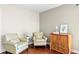 Cozy sitting area features wood floors, striped chairs, and a wooden cabinet at 2935 Winglewood Cir, Lutz, FL 33558